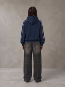 Model wearing the SM Insignia Parallel Hoodie in Oxford Navy, rear view.