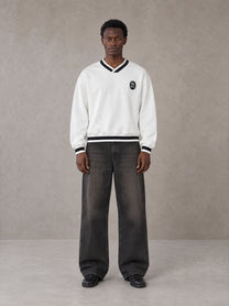 Model wearing the SM Insignia Sweatshirt in Lucent White, front view.