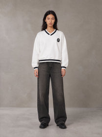 Model wearing the SM Insignia Sweatshirt in Lucent White, front view.