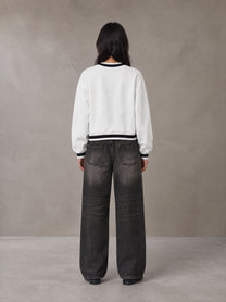 Model wearing the SM Insignia Sweatshirt in Lucent White, rear view.