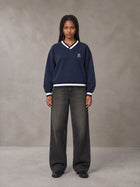 Model wearing the SM Insignia Sweatshirt in Oxford Navy, front view.