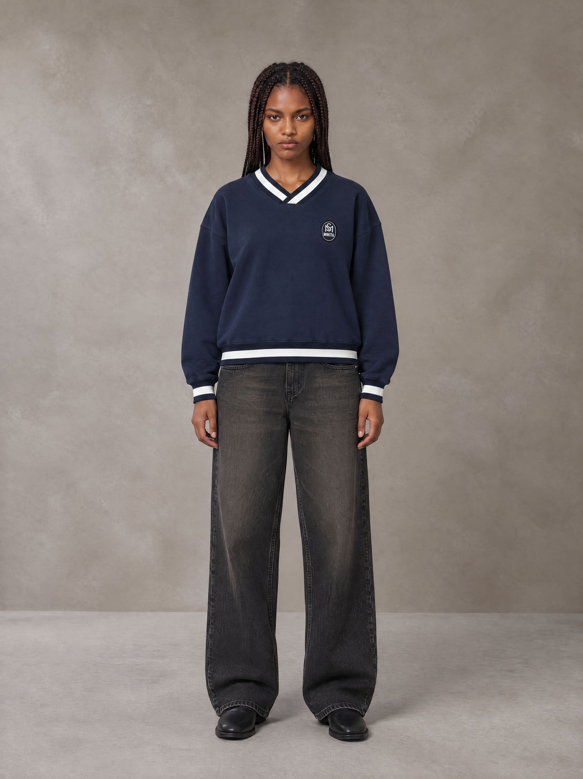 Model wearing the SM Insignia Sweatshirt in Oxford Navy, front view.