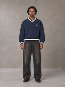 Model wearing the SM Insignia Sweatshirt in Oxford Navy, front view.