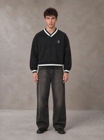 Model wearing the SM Insignia Sweatshirt in Midnight Black, front view.