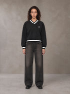 Model wearing the SM Insignia Sweatshirt in Midnight Black, front view.