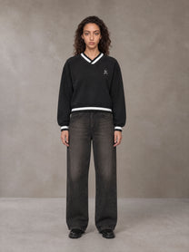 Model wearing the SM Insignia Sweatshirt in Midnight Black, front view.