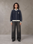 Model wearing the SM Insignia Trim Track Jacket in Oxford Navy, front view.