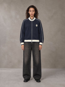 Model wearing the SM Insignia Trim Track Jacket in Oxford Navy, front view.