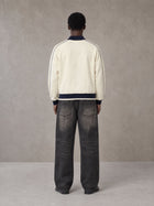 Model wearing the SM Insignia Trim Track Jacket in Classic Cream, rear view.