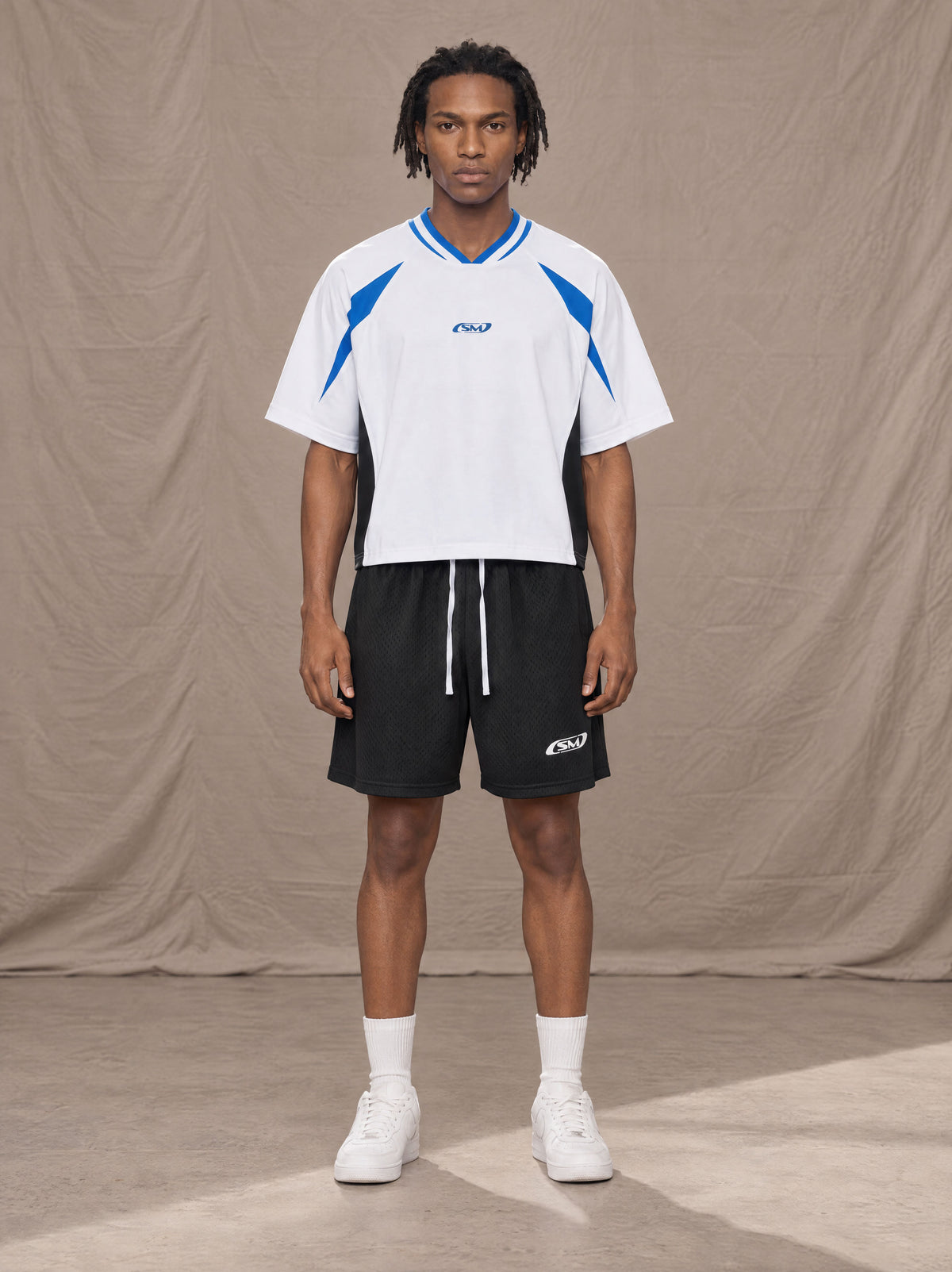 Model wearing the SM Motion Vector Jersey in Lucent White, front view.
