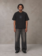 Model wearing the SM Jacquard Knitted Royal Emblem Knitted T-shirt in Midnight Black, front view.