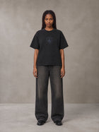 Model wearing the SM Jacquard Knitted Royal Emblem Knitted T-shirt in Midnight Black, front view.