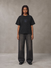 Model wearing the SM Jacquard Knitted Royal Emblem Knitted T-shirt in Midnight Black, front view.