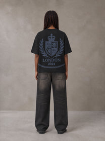 Model wearing the SM Jacquard Knitted Royal Emblem Knitted T-shirt in Midnight Black, rear view.