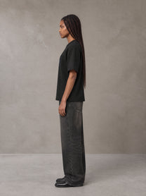 Model wearing the SM Jacquard Knitted Royal Emblem Knitted T-shirt in Midnight Black, side profile.