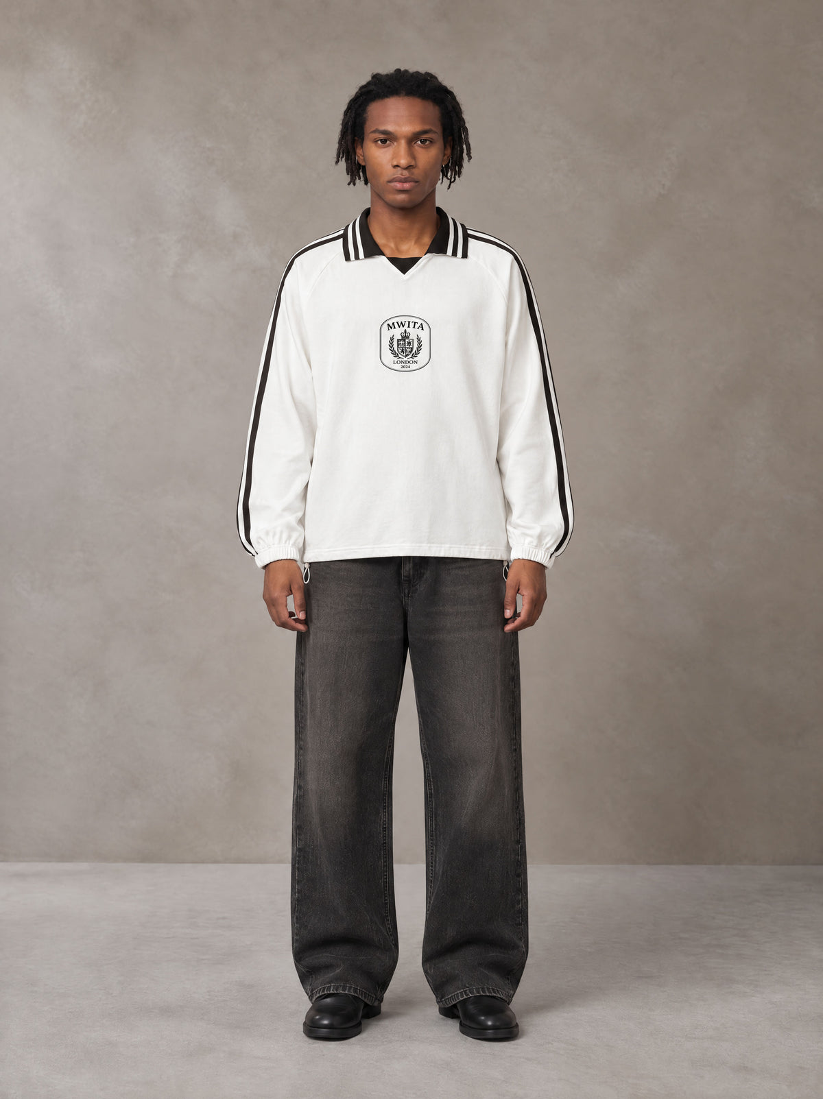 Model wearing the SM Royal Emblem Panel Sweatshirt in Lucent White, front view.