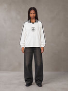 Model wearing the SM Royal Emblem Panel Sweatshirt in Lucent White, front view.