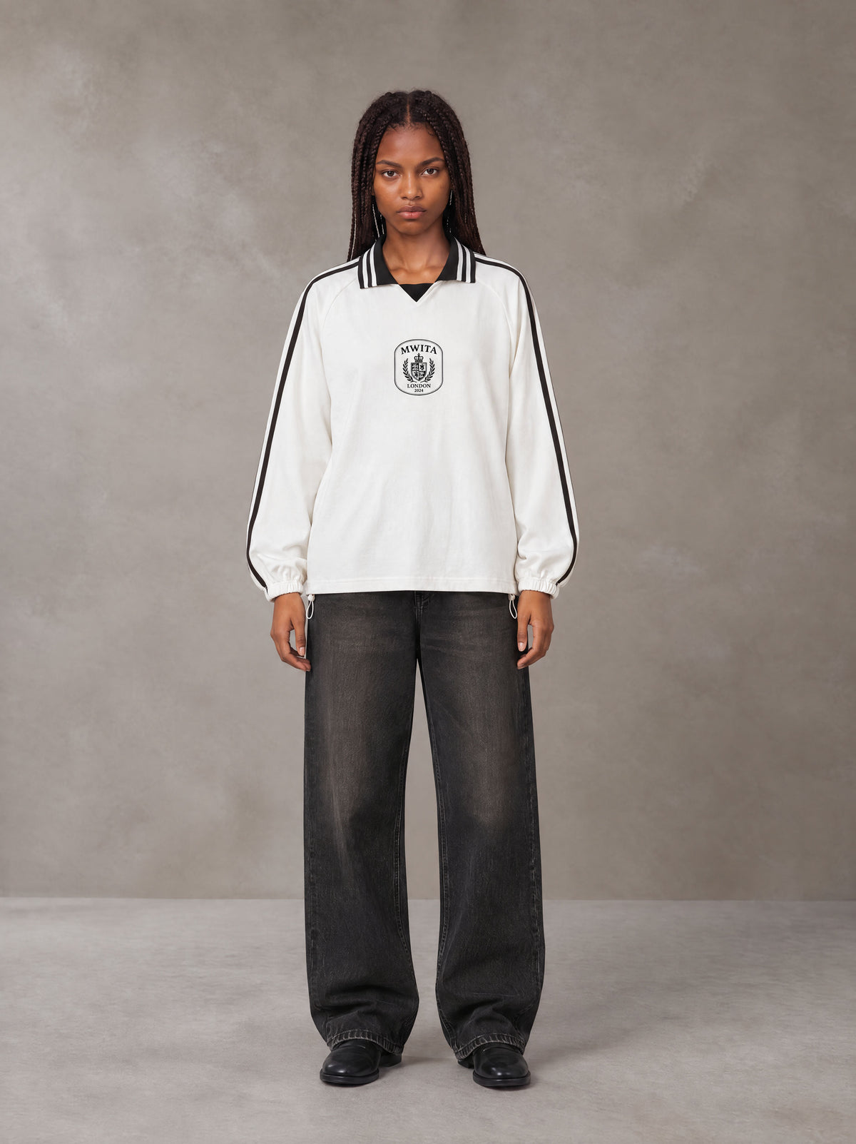 Model wearing the SM Royal Emblem Panel Sweatshirt in Lucent White, front view.