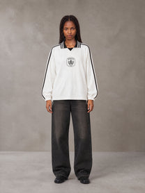 Model wearing the SM Royal Emblem Panel Sweatshirt in Lucent White, front view.