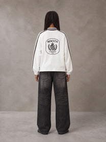 Model wearing the SM Royal Emblem Panel Sweatshirt in Lucent White, rear view.