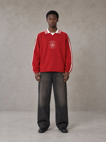 Model wearing the SM Royal Emblem Panel Sweatshirt in Crimson, front view.