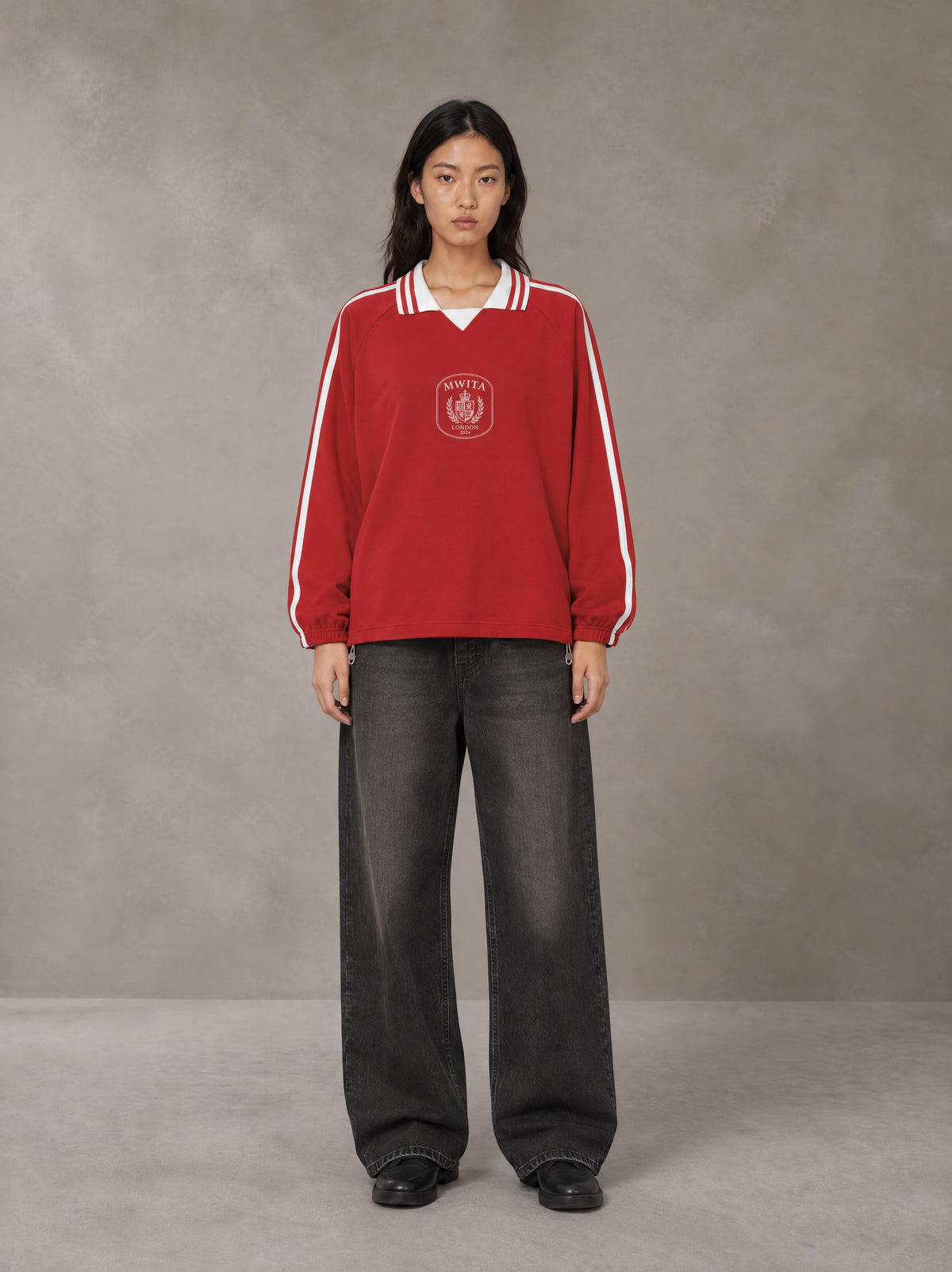 Model wearing the SM Royal Emblem Panel Sweatshirt in Crimson, front view.