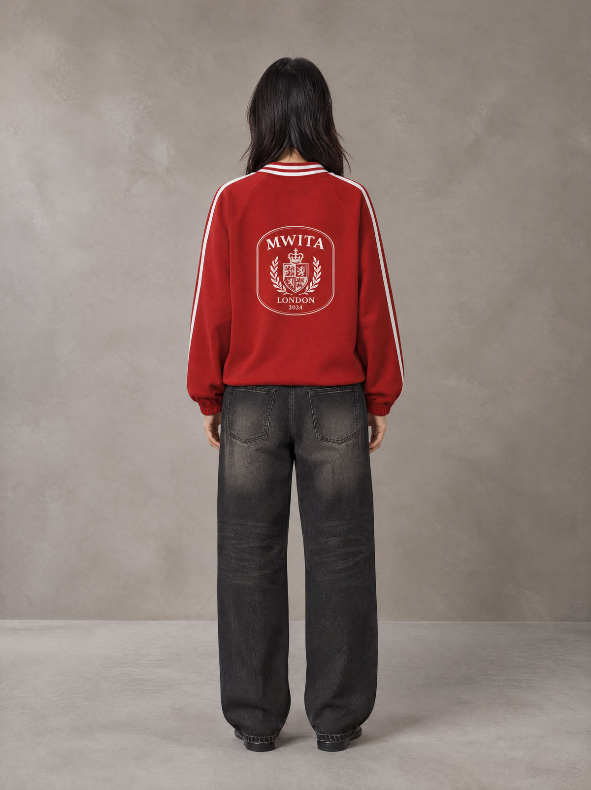 Model wearing the SM Royal Emblem Panel Sweatshirt in Crimson, rear view.