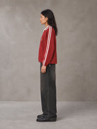 Model wearing the SM Royal Emblem Panel Sweatshirt in Crimson, side profile.