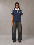 Model wearing the SM Royal Emblem Polo T-shirt in Oxford Navy, front view.