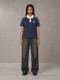 Model wearing the SM Royal Emblem Polo T-shirt in Oxford Navy, front view.
