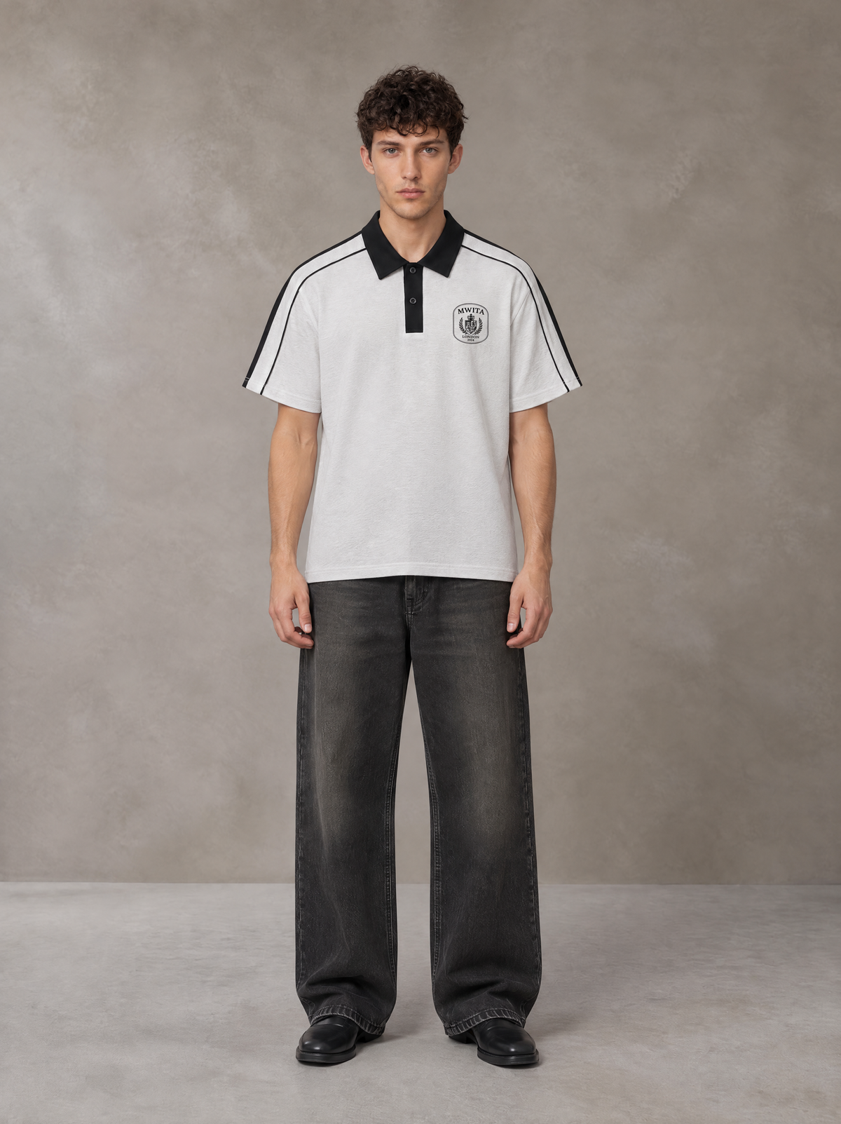 Model wearing the SM Royal Emblem Polo T-shirt in Floral Grey, front view.