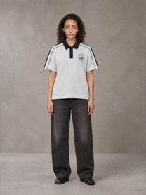 Model wearing the SM Royal Emblem Polo T-shirt in Floral Grey, front view.