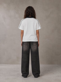 Model wearing the SM Royal Emblem Polo T-shirt in Floral Grey, rear view.