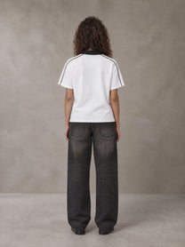 Model wearing the SM Royal Emblem Polo T-shirt in Lucent White, rear view.