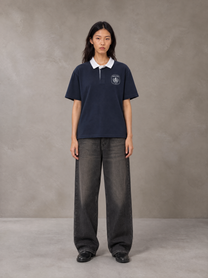 Model wearing the SM Royal Emblem Polo T-shirt in Oxford Navy, front view.