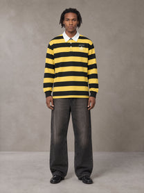 Model wearing the SM Royal Emblem Rugby Polo T-shirt in Arylide Yellow, front view.