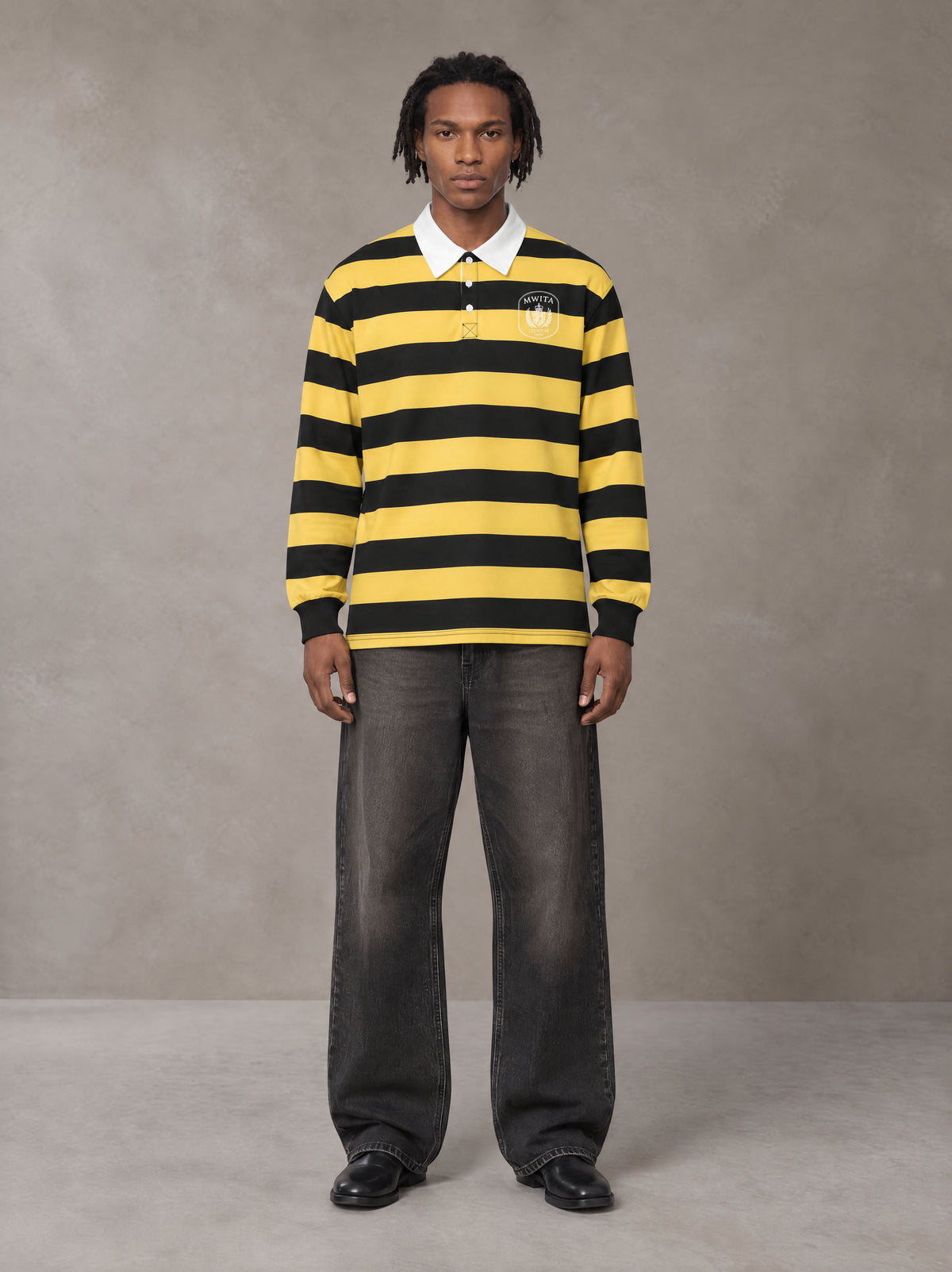 Model wearing the SM Royal Emblem Rugby Polo T-shirt in Arylide Yellow, front view.
