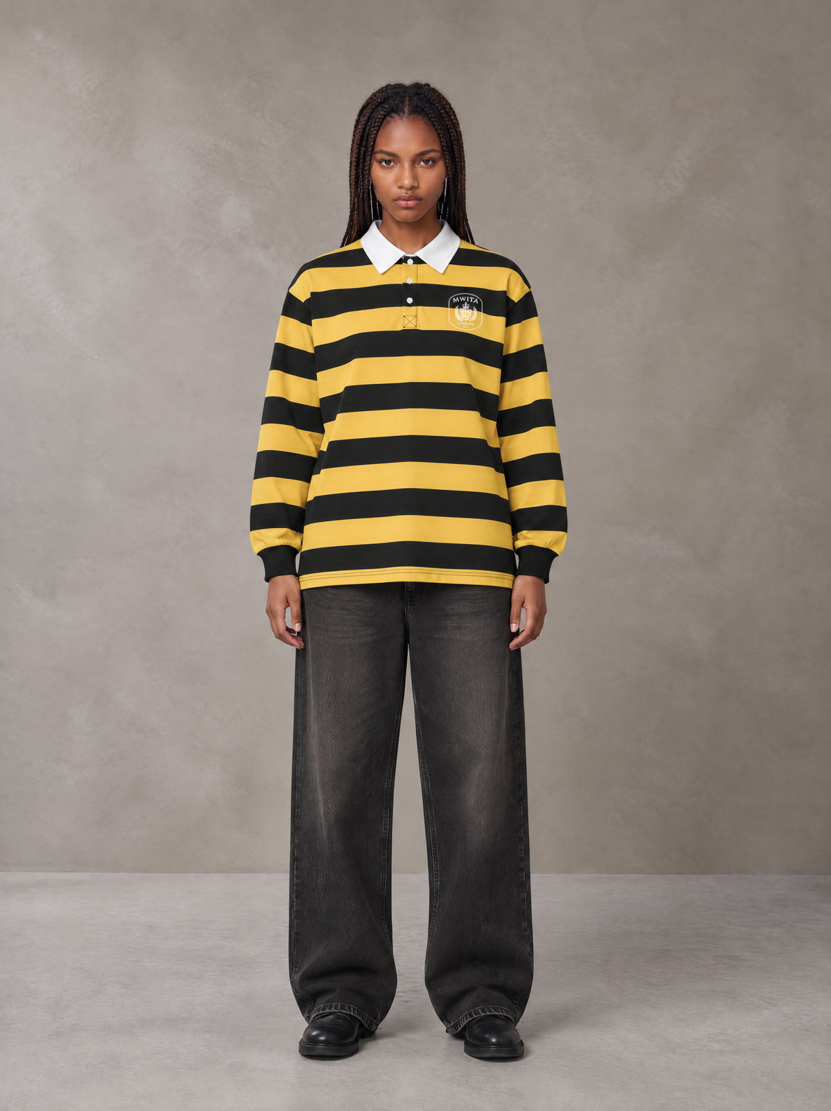 Model wearing the SM Royal Emblem Rugby Polo T-shirt in Arylide Yellow, front view.