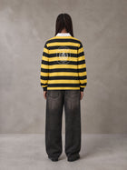 Model wearing the SM Royal Emblem Rugby Polo T-shirt in Arylide Yellow, rear view.