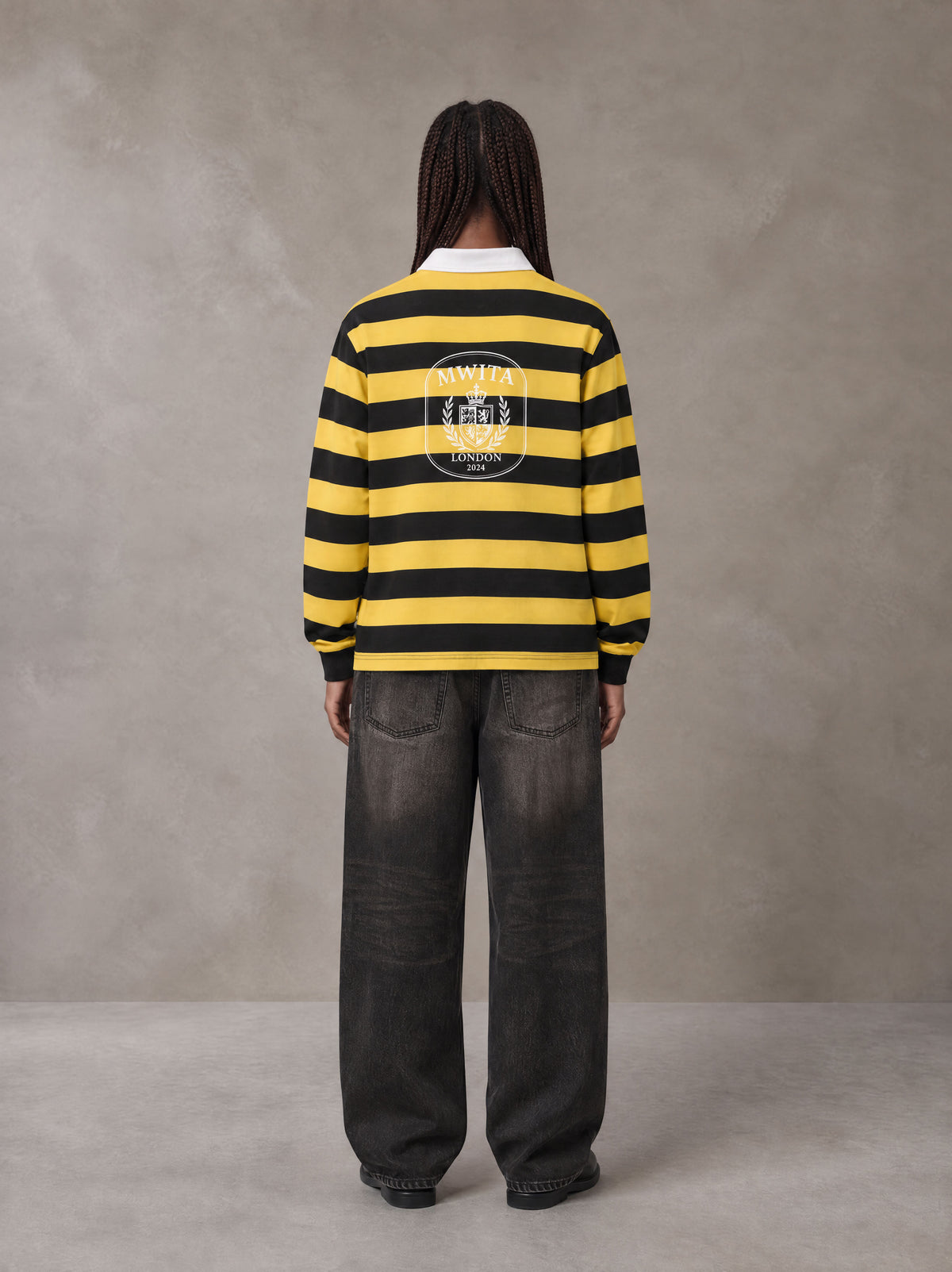 Model wearing the SM Royal Emblem Rugby Polo T-shirt in Arylide Yellow, rear view.
