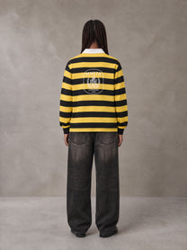 Model wearing the SM Royal Emblem Rugby Polo T-shirt in Arylide Yellow, rear view.