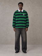 Model wearing the SM Royal Emblem Rugby Polo T-shirt in Dark Spring Green, front view.