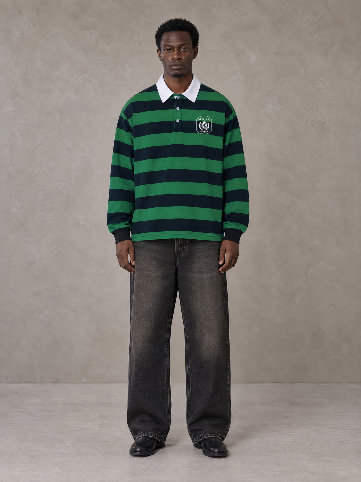Model wearing the SM Royal Emblem Rugby Polo T-shirt in Dark Spring Green, front view.