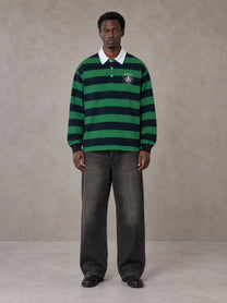 Model wearing the SM Royal Emblem Rugby Polo T-shirt in Dark Spring Green, front view.