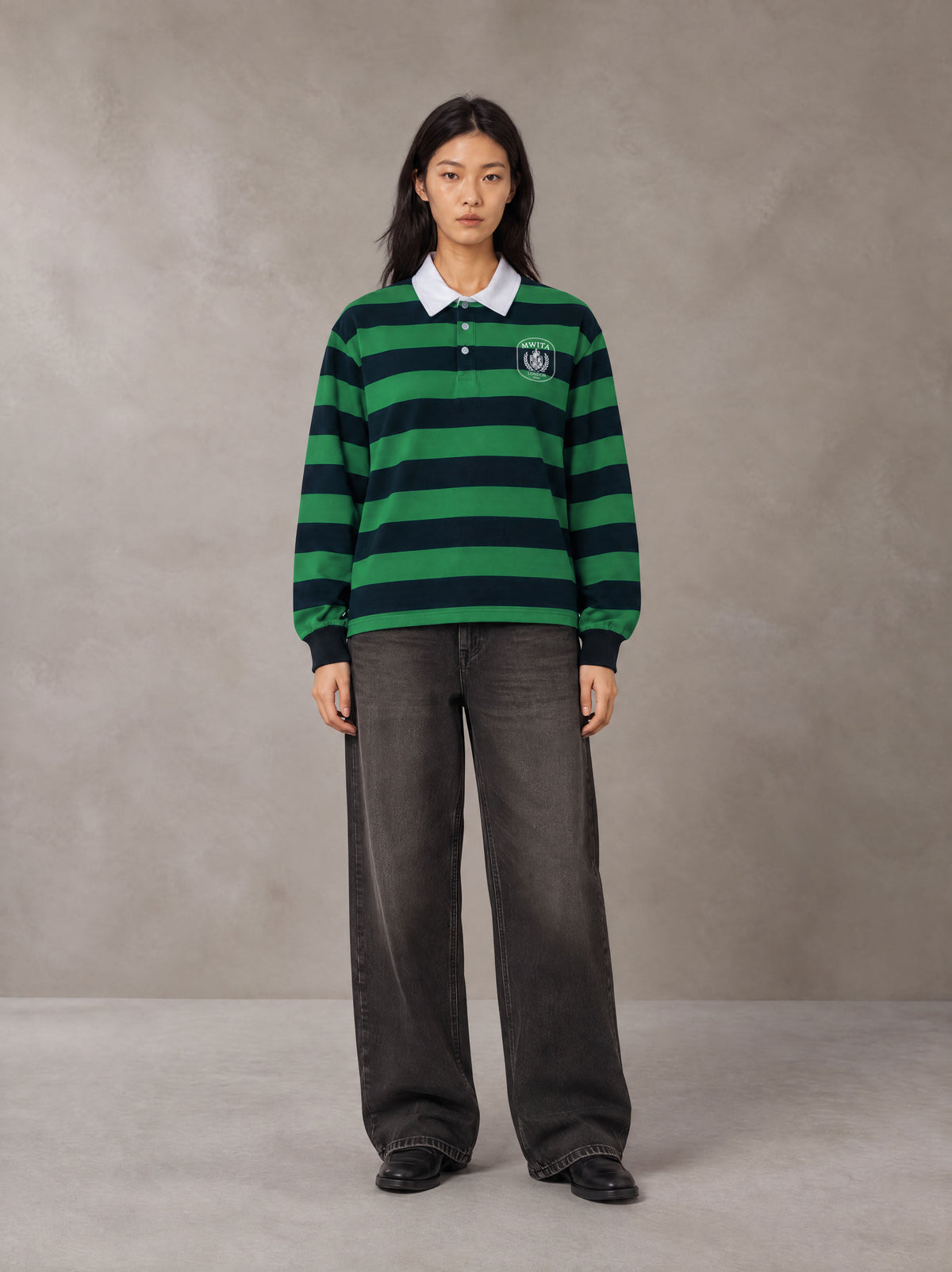 Model wearing the SM Royal Emblem Rugby Polo T-shirt in Dark Spring Green, front view.