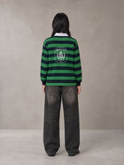 Model wearing the SM Royal Emblem Rugby Polo T-shirt in Dark Spring Green, rear view.