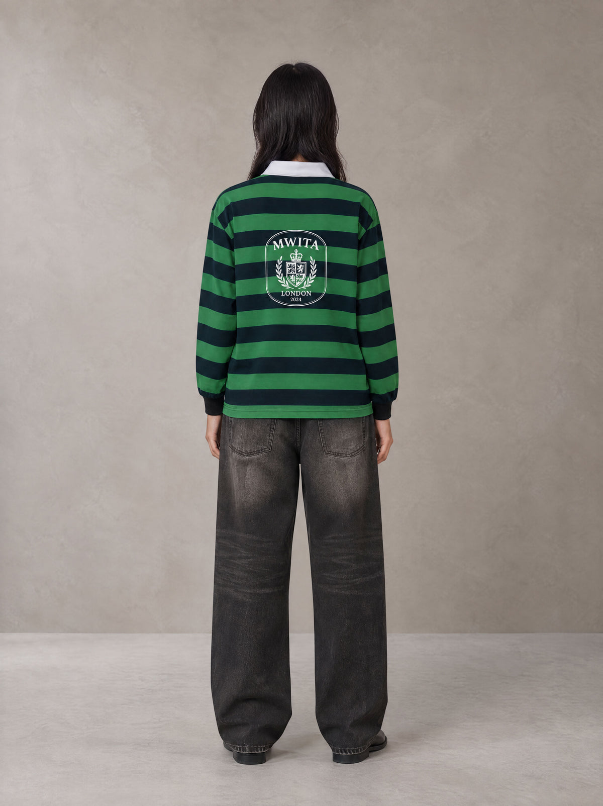 Model wearing the SM Royal Emblem Rugby Polo T-shirt in Dark Spring Green, rear view.