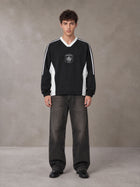 Model wearing the SM Royal Emblem Sport Sweatshirt in Midnight Black, front view.