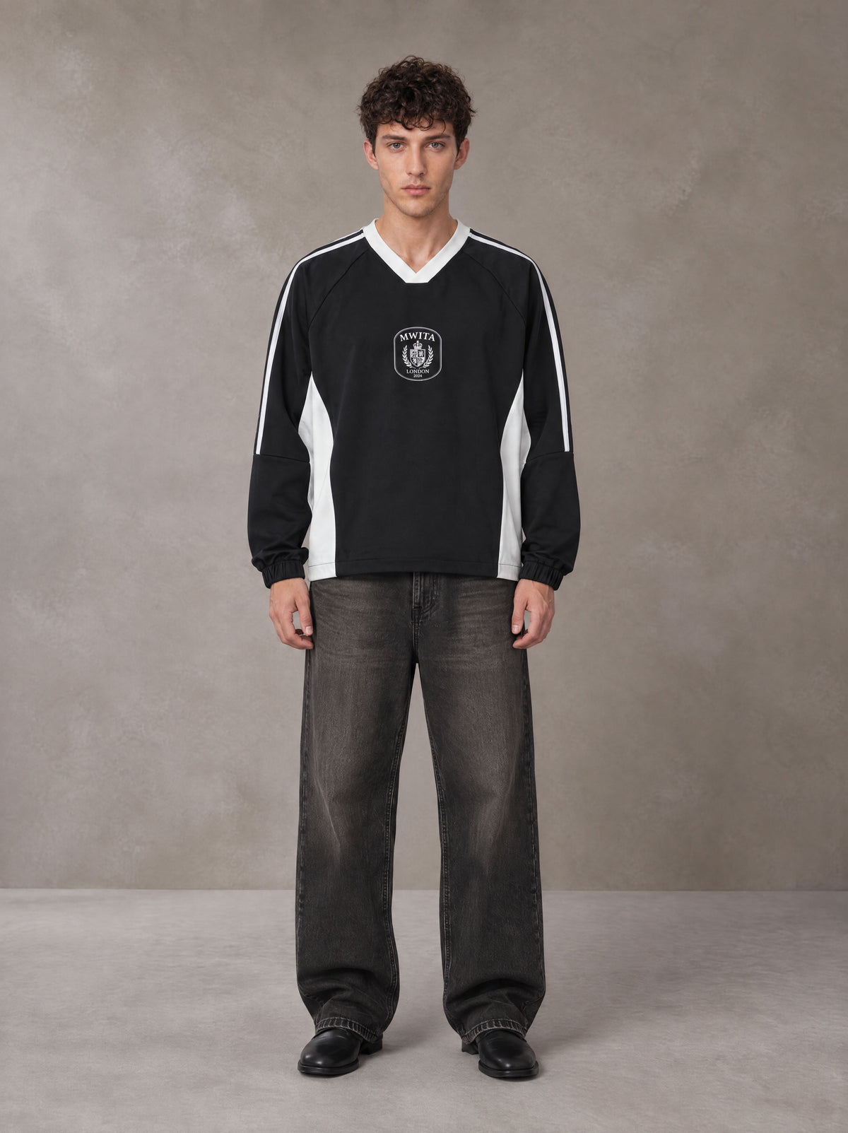 Model wearing the SM Royal Emblem Sport Sweatshirt in Midnight Black, front view.