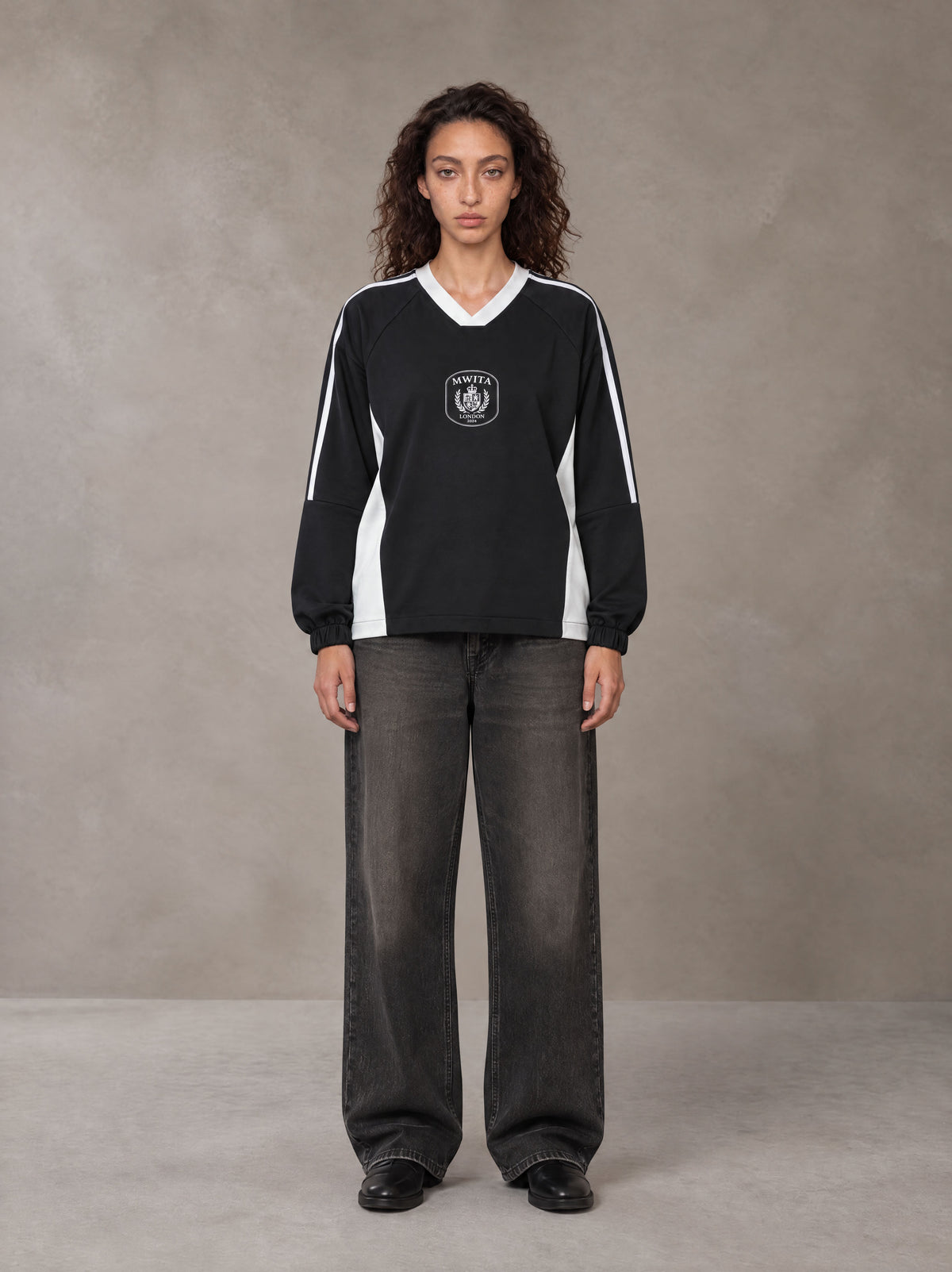 Model wearing the SM Royal Emblem Sport Sweatshirt in Midnight Black, front view.